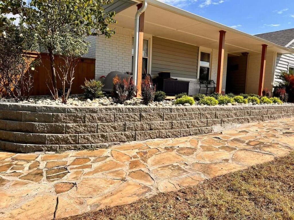 10. Raised Stone Planter with Evergreen Contrast