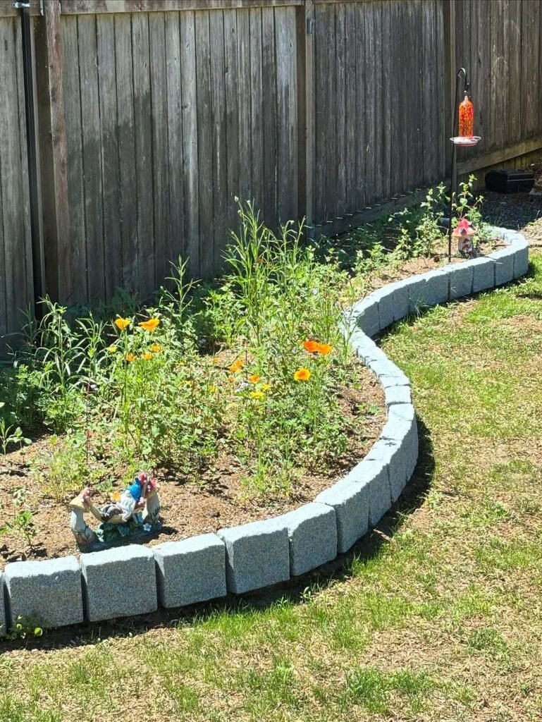 20. Curved Natural Flower Bed for a Whimsical Garden Feel