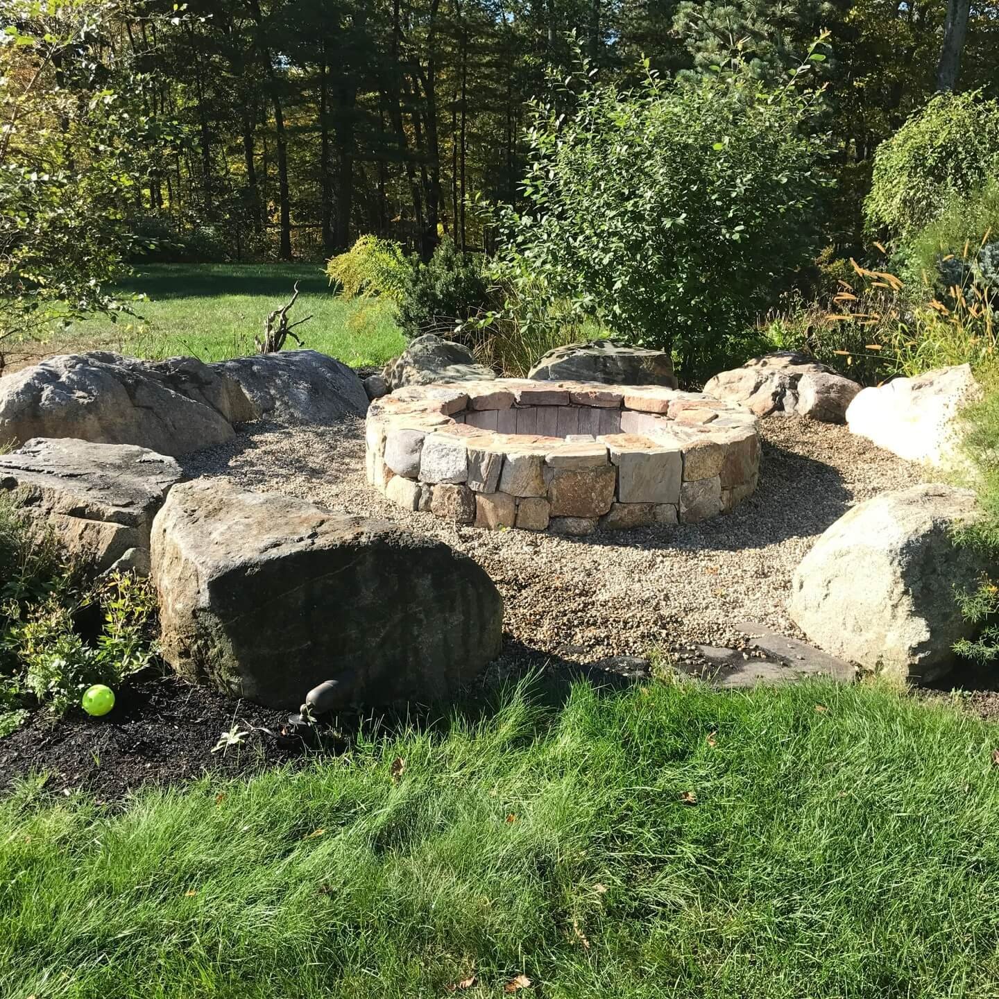 Natural Fire Pit Boulder-Enclosed Fire Pit with Gravel Ground Cover