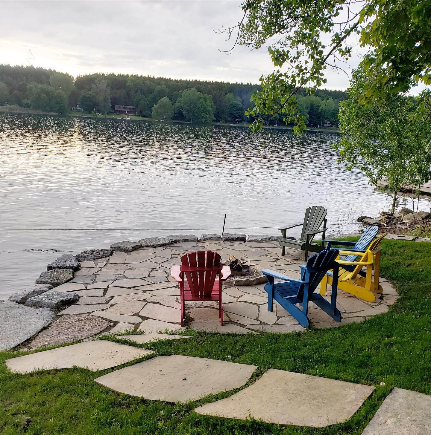 Natural Fire Pit Lakefront Stone Fire Pit with Adirondack Chairs
