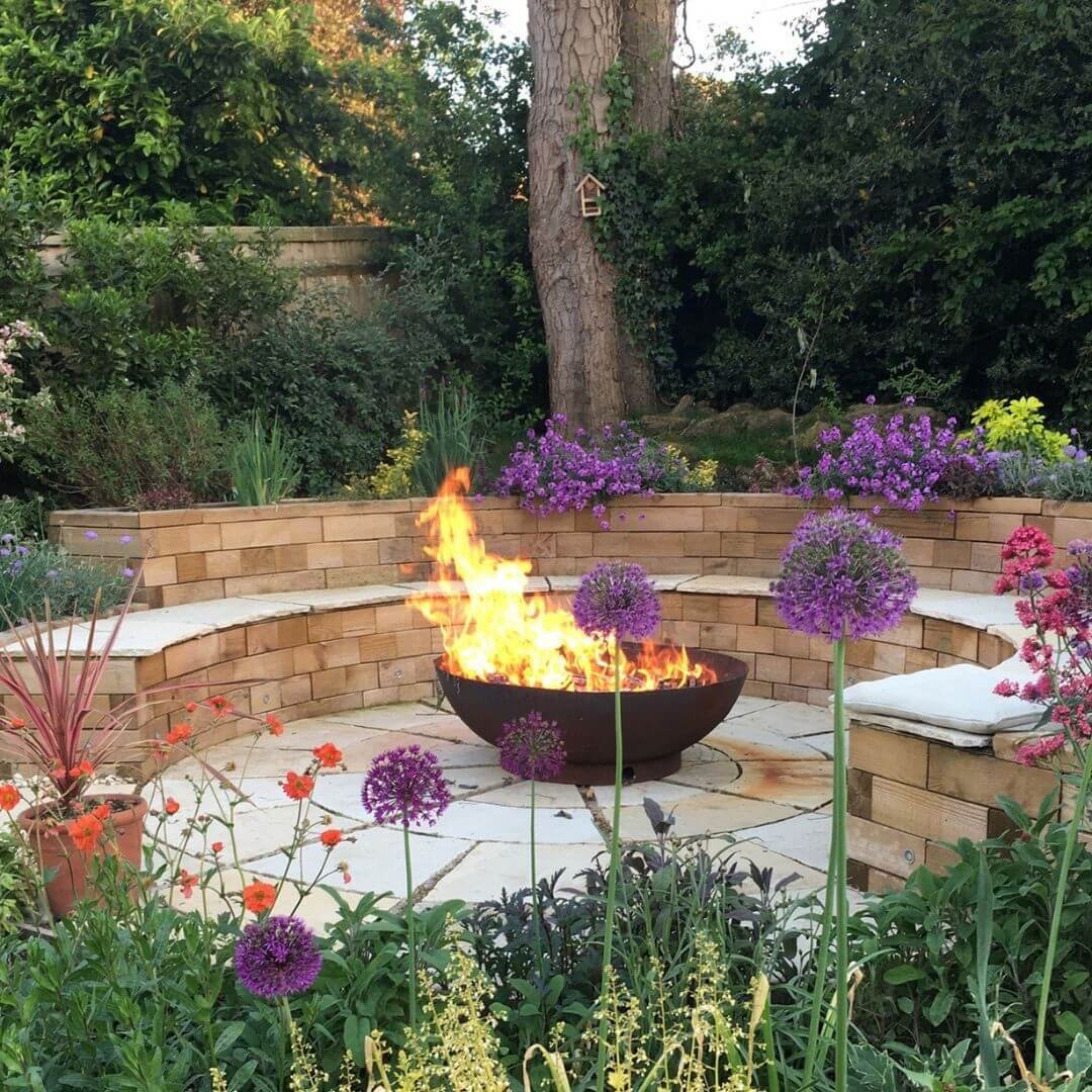  Fire Pit Seating Area Ideas Tiered Garden Retreat with Blooming Backdrop