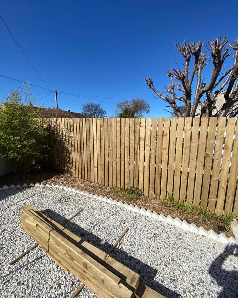 25. Vertical Pale Fence for Breezy Backyard Style